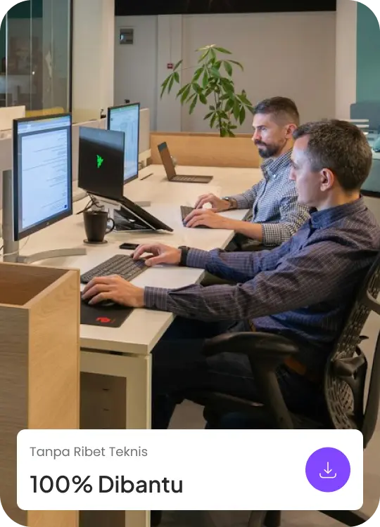 Dua staf IT profesional sedang bekerja di kantor memantau dashboard sistem informasi desa dan melakukan maintenance teknis untuk memastikan website desa berjalan lancar.